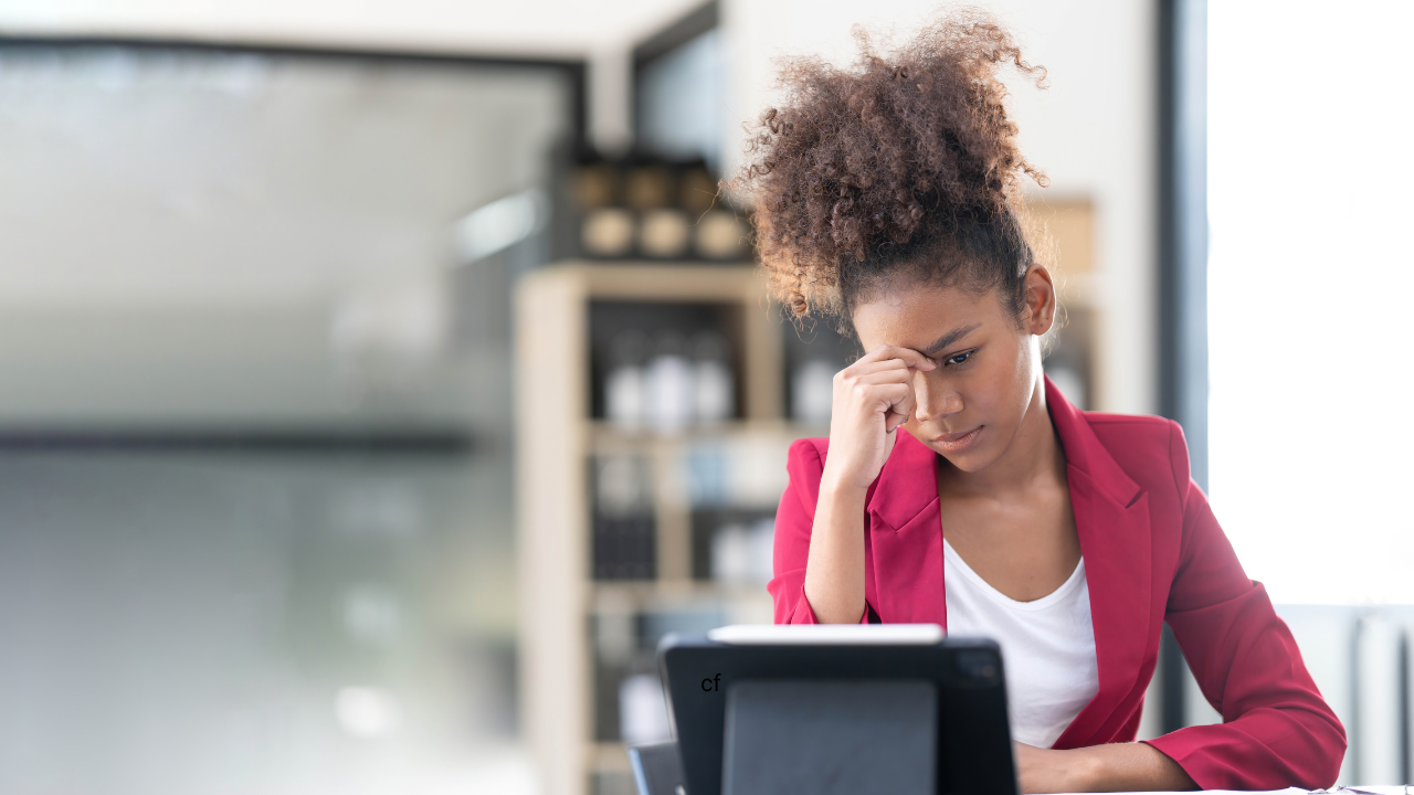 woman sitting at computer realizing she made a mistake